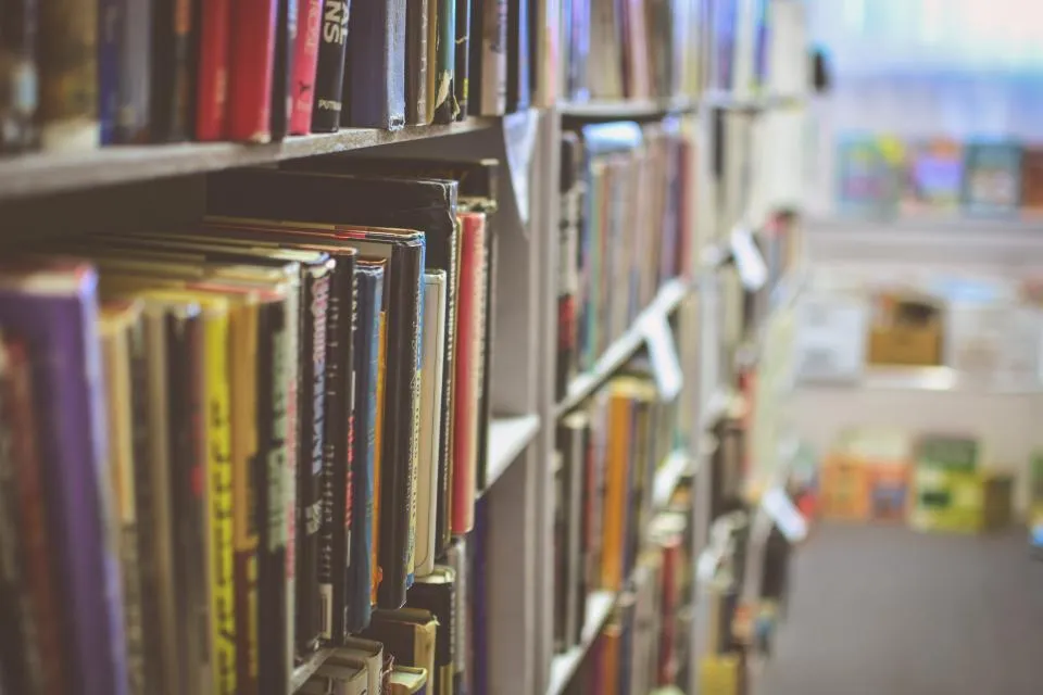 Library aisle lined with shelves of borrowed and returned books